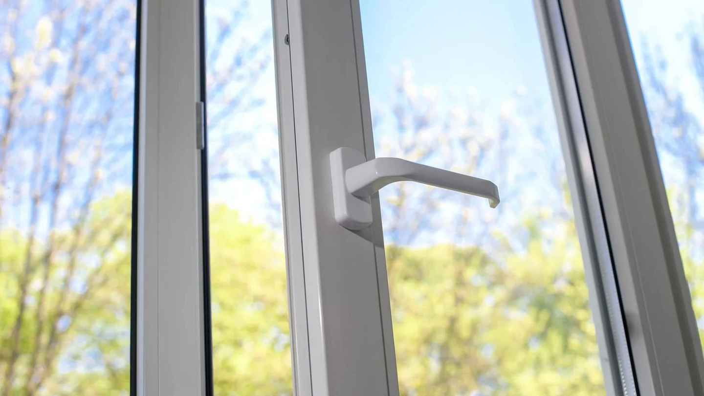 Ein Fenster steht offen. Im Hintergrund sind B&auml;ume und ein blauer Himmel zu sehen.